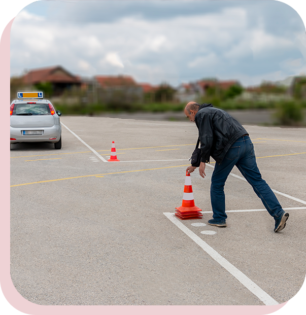 A man is standing in the middle of an empty parking lot.